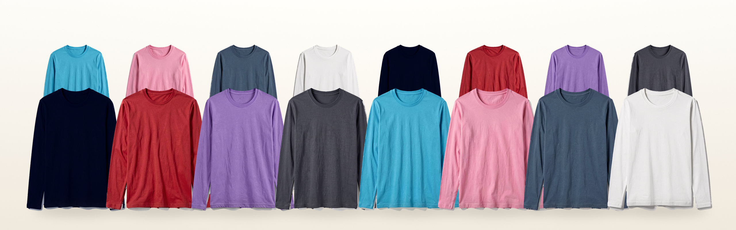 Blank long-sleeve tees in eight colors, lined up in two rows on a warm white background